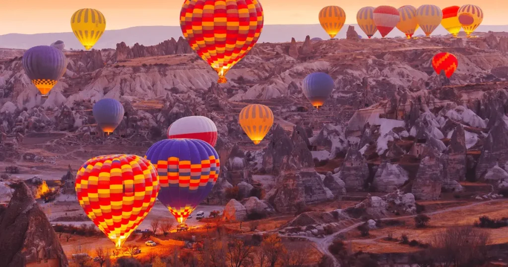 Float serenely over the magical landscapes at sunrise in a hot air balloon.